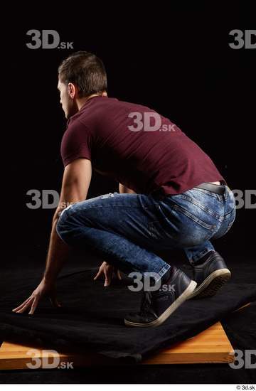 Tomas Salek  blue jeans dressed grey shoes kneeling red t shirt whole body  jpg